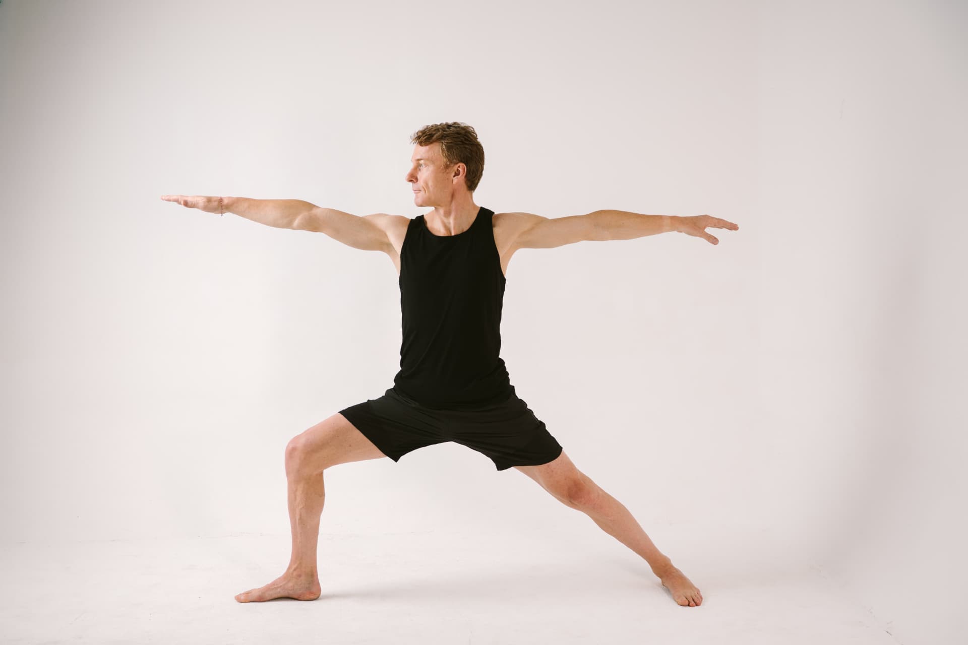 Petr Bena in Warrior II pose